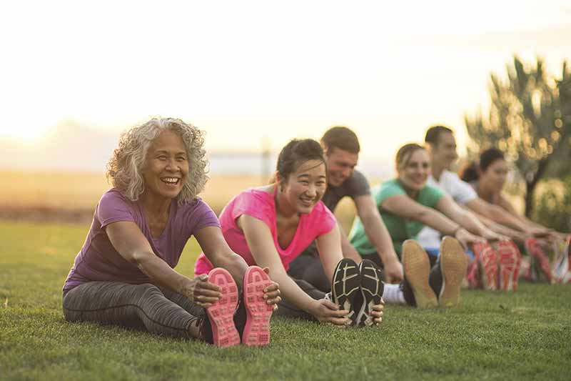 group exercise in a public park at sunset