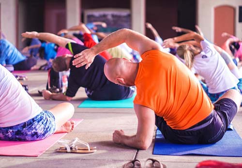 group of business people taking a yoga class